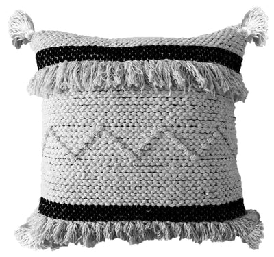 Throw pillow with black and beige stripes and tassels at corners on a sofa