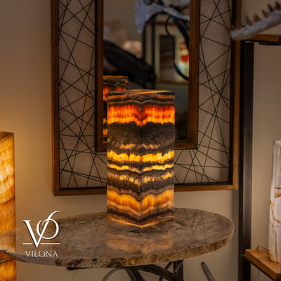 Tangerine Onyx Table Lamp with bright orange glowing band and layered natural stone pattern