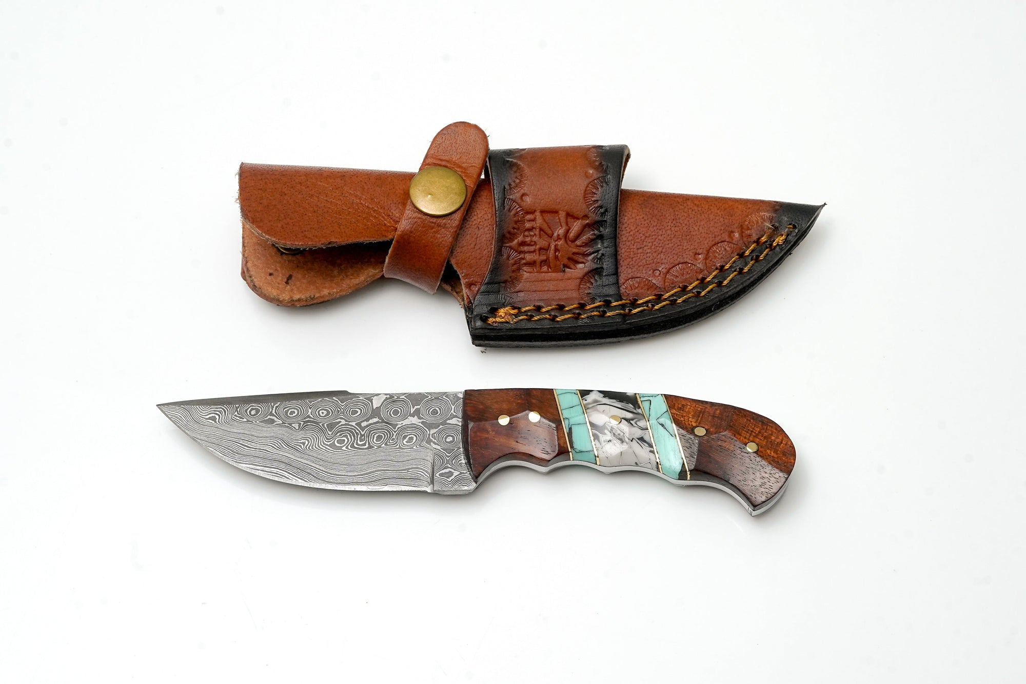Hand-Forged Damascus Steel Field Knife with custom hybrid wood and turquoise handle resting on a black surface
