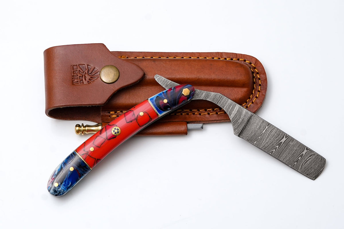 Damascus straight razor TK-500 showing its patterned steel blade and Micarta handle with brass spacers