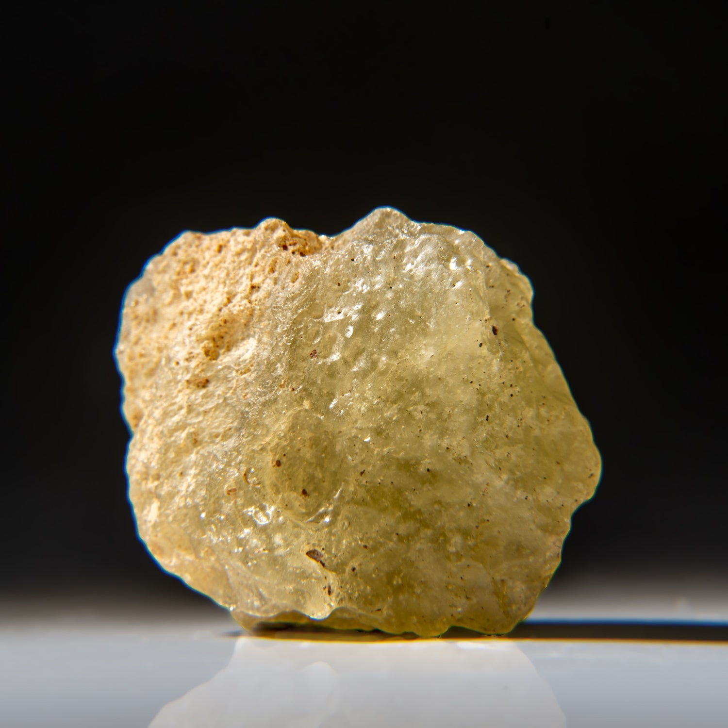 Genuine Libyan Desert Glass specimen weighing 31 grams with rough natural edges and smooth surfaces in earth-tone hues