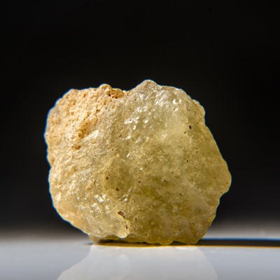 Genuine Libyan Desert Glass specimen weighing 31 grams with rough natural edges and smooth surfaces in earth-tone hues