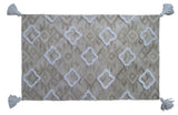 Tufted Shatter rug with diamond pattern and corner fringes laid on flooring