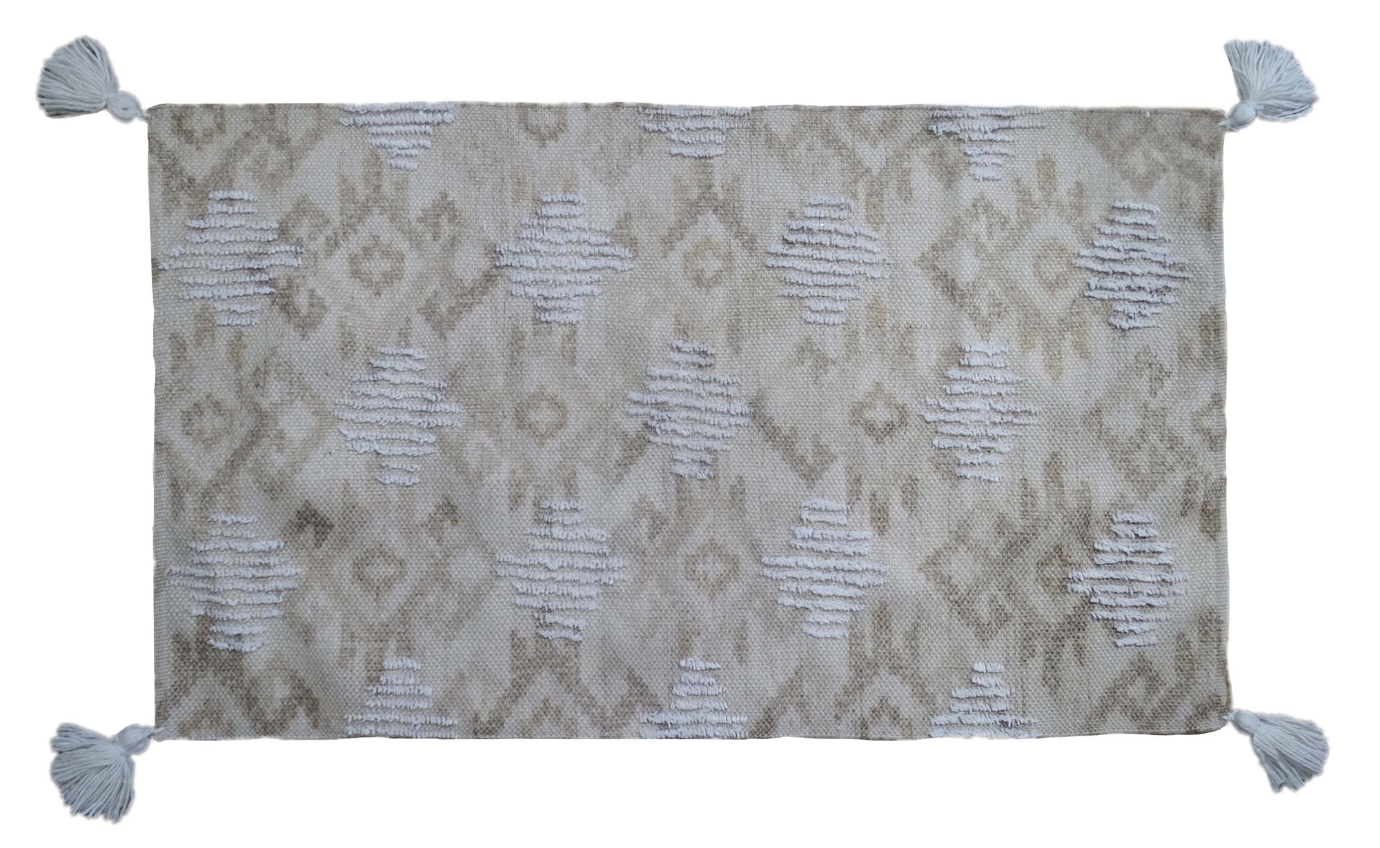 Tufted accent rug in beige tones with corner fringes laid on a tile floor
