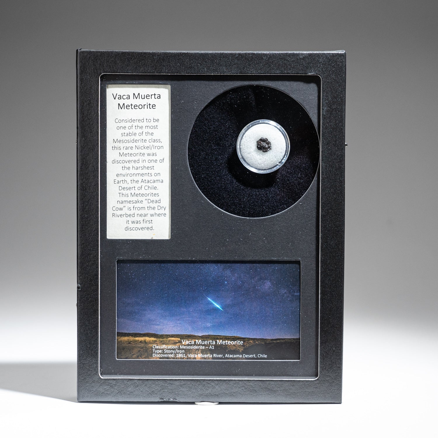 Genuine Vaca Muerta meteorite specimen displayed in a clear glass box with label