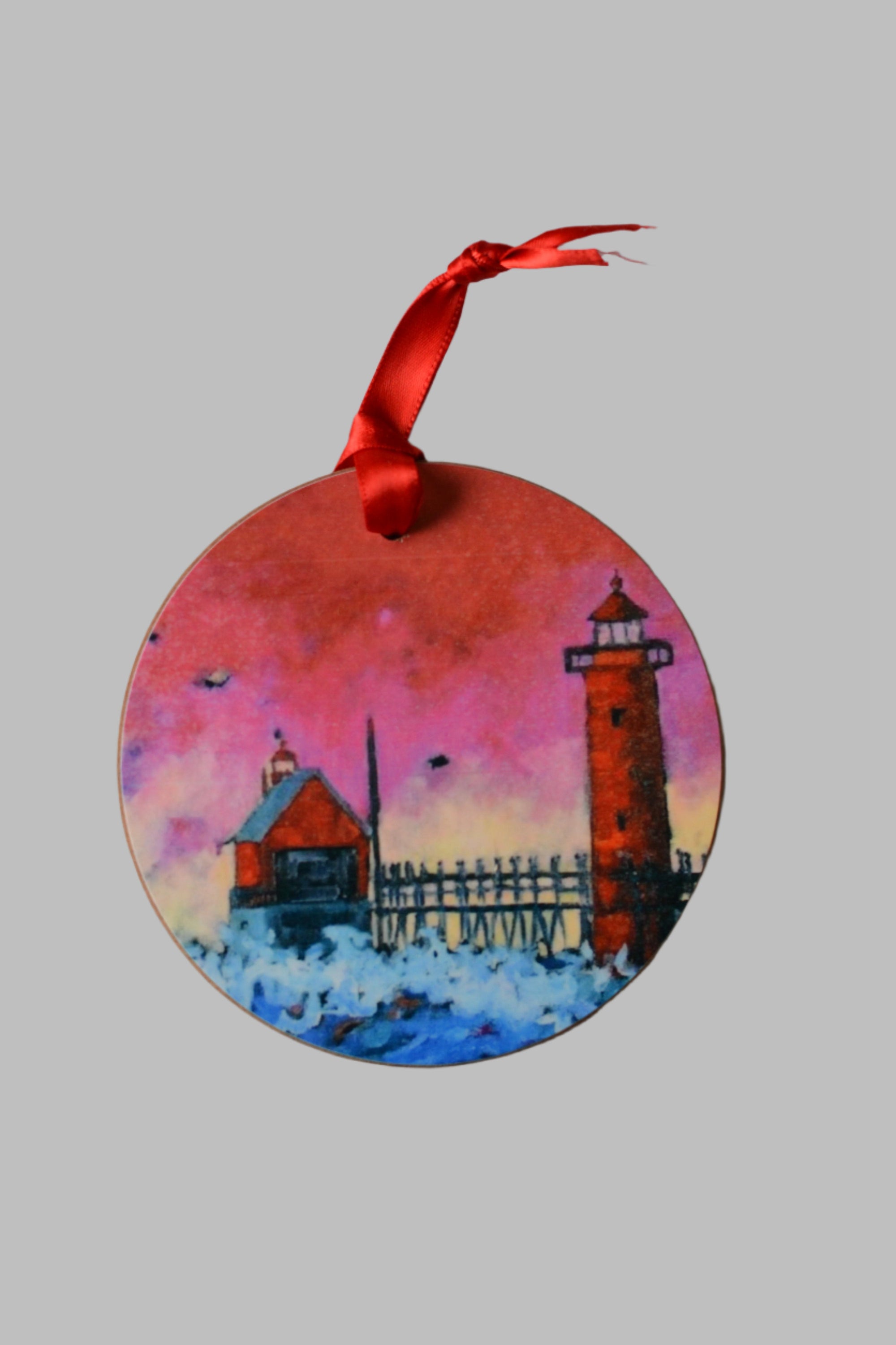 Grand Haven Lighthouse Ornament featuring Pink Sky at Night artwork with satin red hanging ribbon