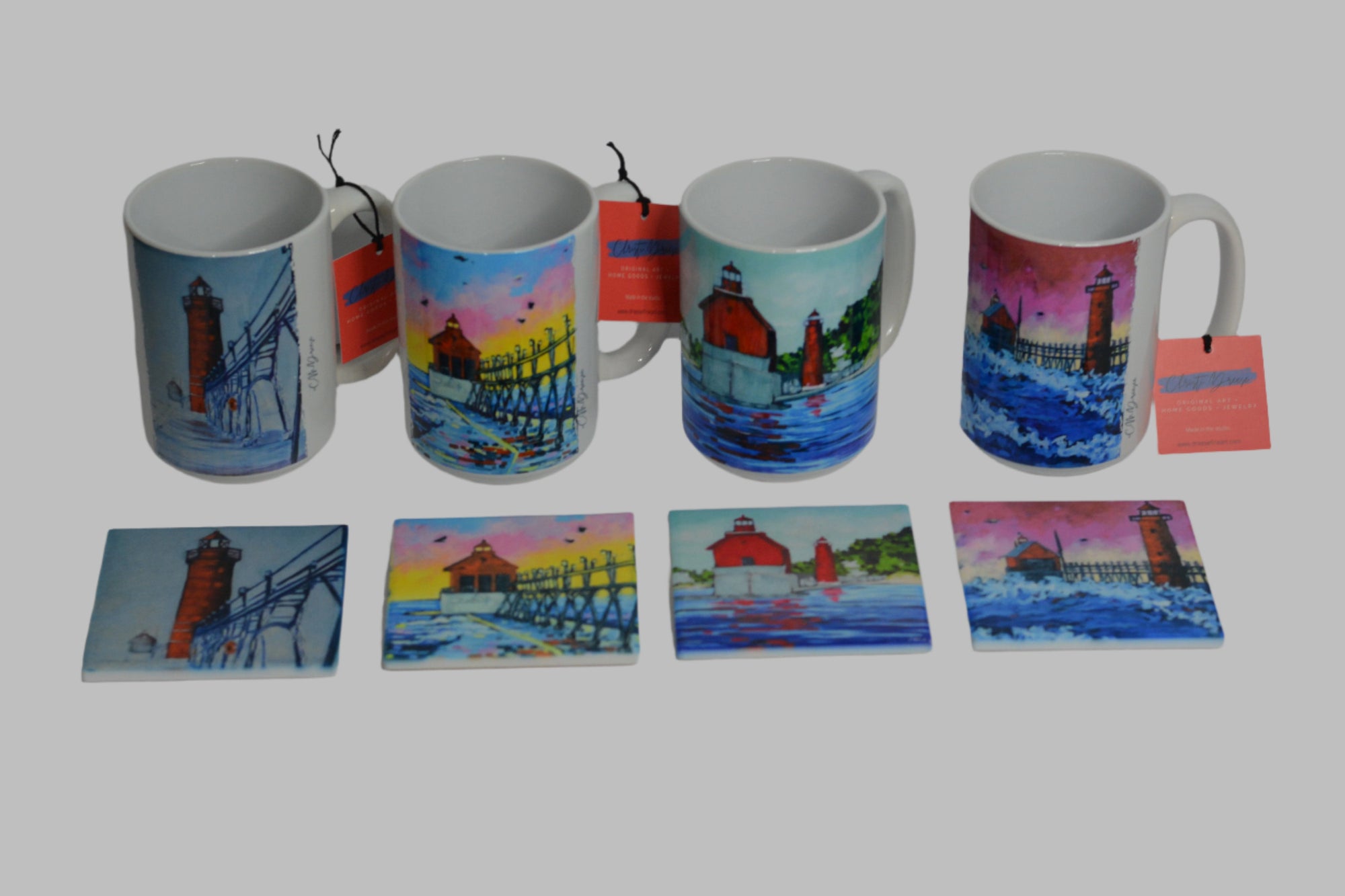 Four 15 oz coffee mugs and matching Grand Haven Lighthouse coasters arranged in gift set