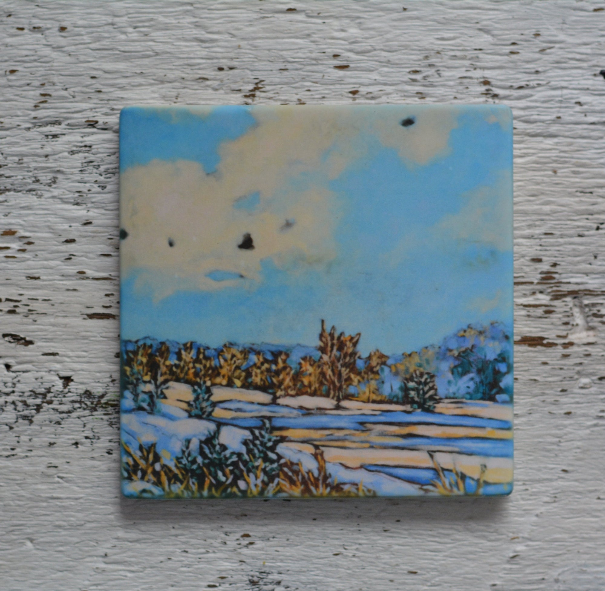 Coaster/ Trivet/ Magnet: Winter's Magic II by Dreese Fine Art on a wooden surface with warm lighting