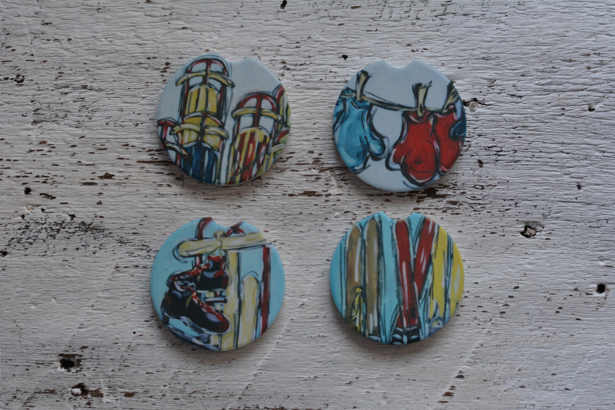 Car coasters decorated with vintage skis, mittens, sleds, and skates designs