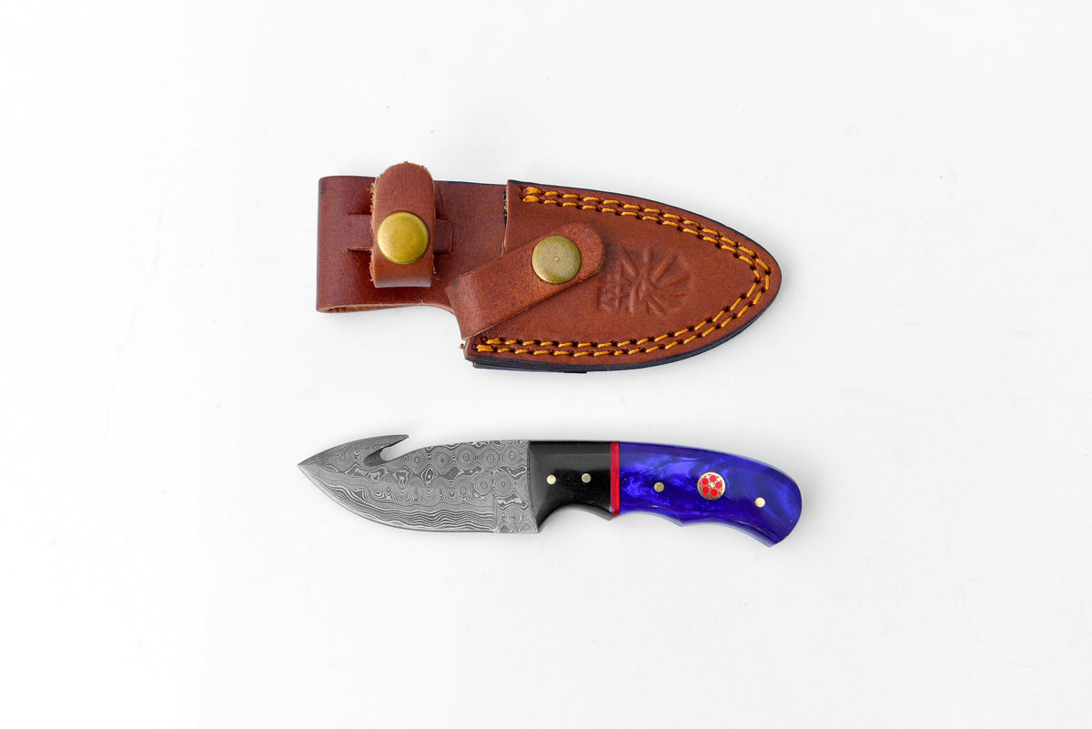 Titan Midnight Talon TK-222 knife showing black and electric blue resin handle and Damascus steel blade with gut hook