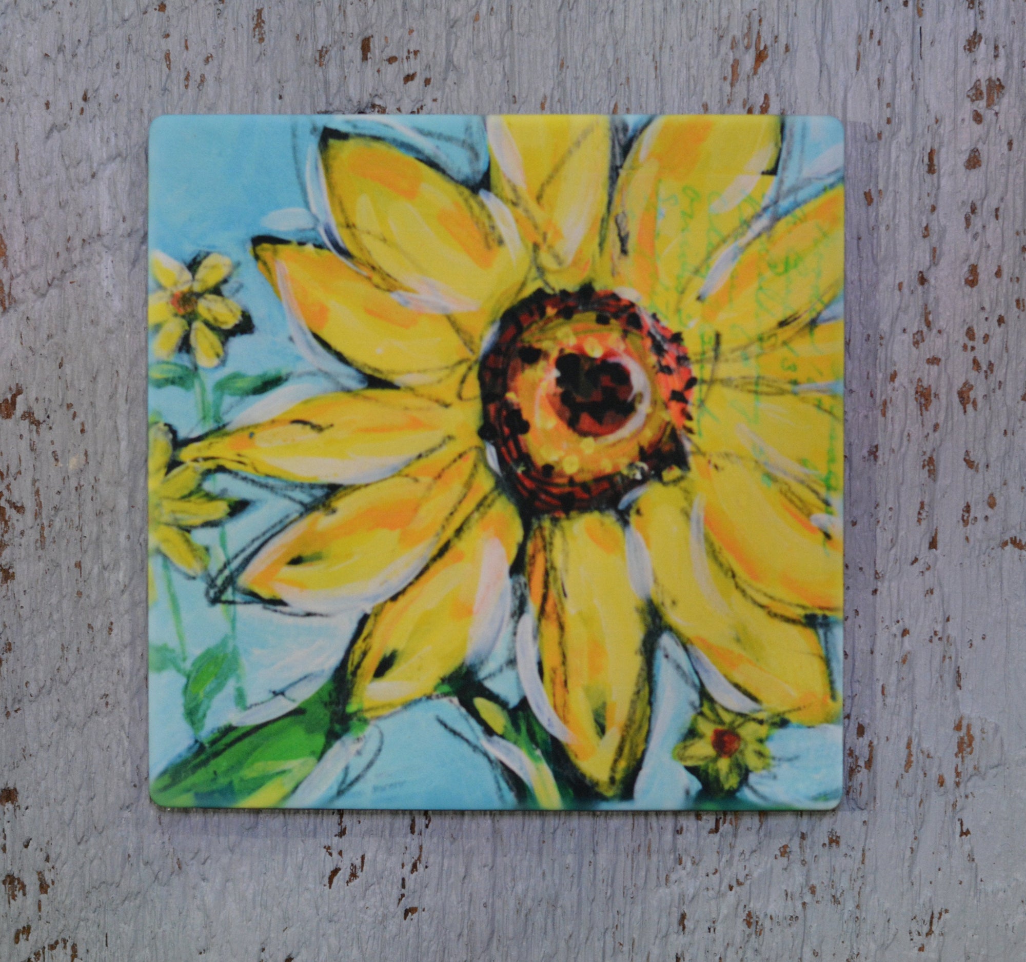 Coaster, trivet, and magnet featuring a bright sunflower design by Dreese Fine Art