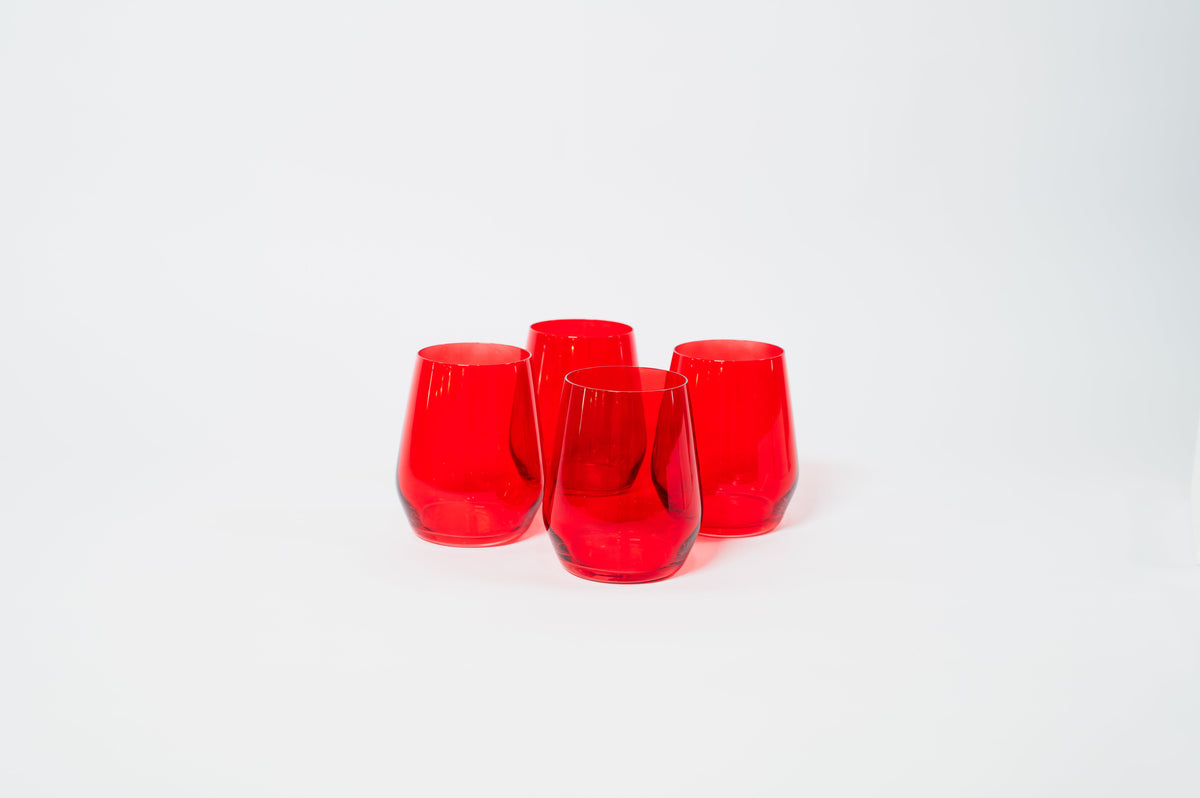 Four stemless wine glasses made of translucent cherry red glass, arranged in a diamond shape on a white background.