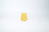 Single transparent yellow wine glass with a gently tapered shape, photographed on a clean white background.