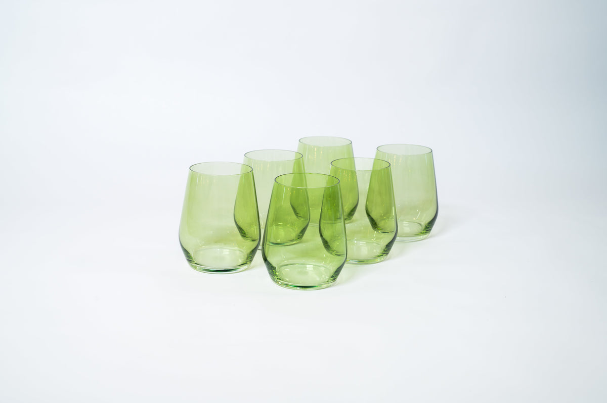Set of six translucent matcha green stemless wine glasses with rounded bases and slightly tapered tops arranged on white background.