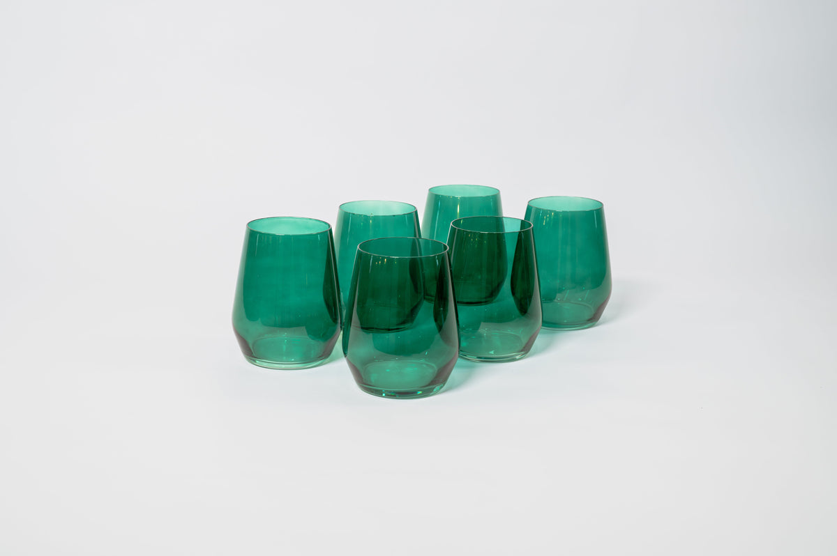 Five emerald green, stemless wine glasses with a smooth, slightly tapered shape grouped on a white background.