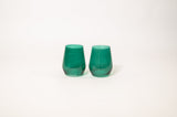 Two emerald green stemless wine glasses with subtle translucent shading, displayed side by side on a plain white background.