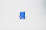 Blue-colored wine glass with a slightly rounded and angular shape, displayed on a plain white background