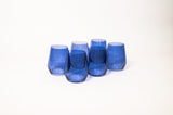 Five blue colored wine glasses with subtle vertical ridges, arranged in a close cluster on a white background.