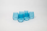 Set of five translucent blue wine glasses with a modern, slightly tapered shape arranged closely on a white background.