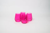 Four translucent hot pink stemless wine glasses grouped closely on a plain white background with smooth curved sides.
