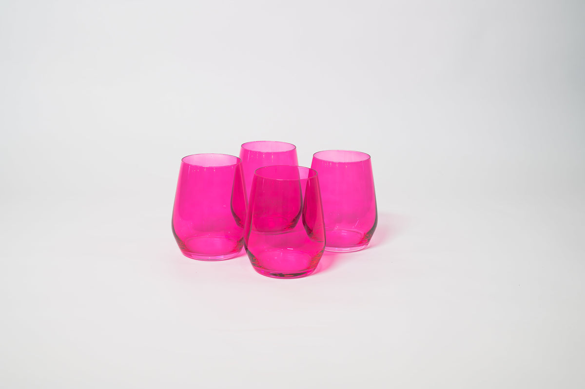 Four translucent hot pink stemless wine glasses grouped closely on a plain white background with smooth curved sides.