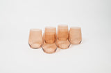 Five translucent brown-tinted wine glasses with smooth, rounded shapes arranged in a slight arc on a white background.