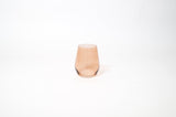 Translucent brown-tinted wine glass with a slightly tapered shape and smooth surface on a white background.