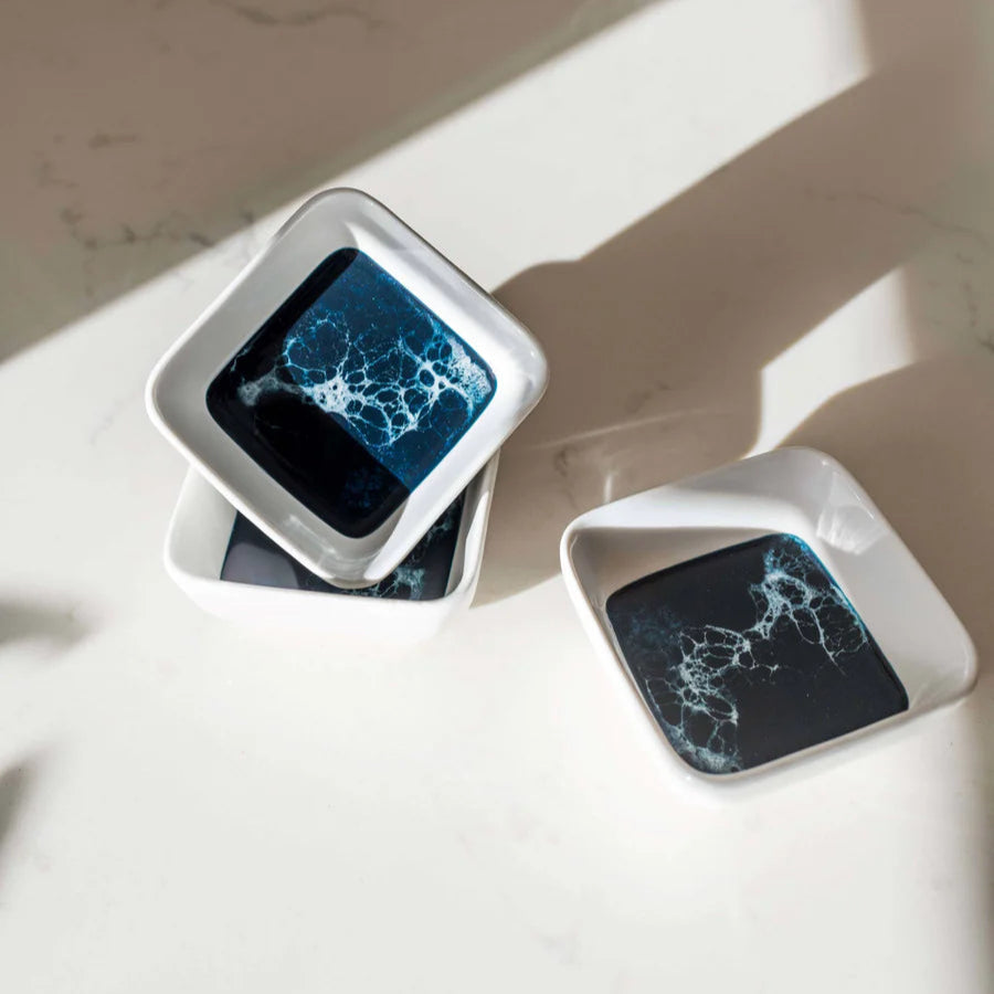 resin ceramic trays a blue abstract design on a marble surface