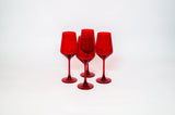 Four cherry red stemmed wine glasses clustered on a white background, each with a modern angular bowl shape and slender stems.