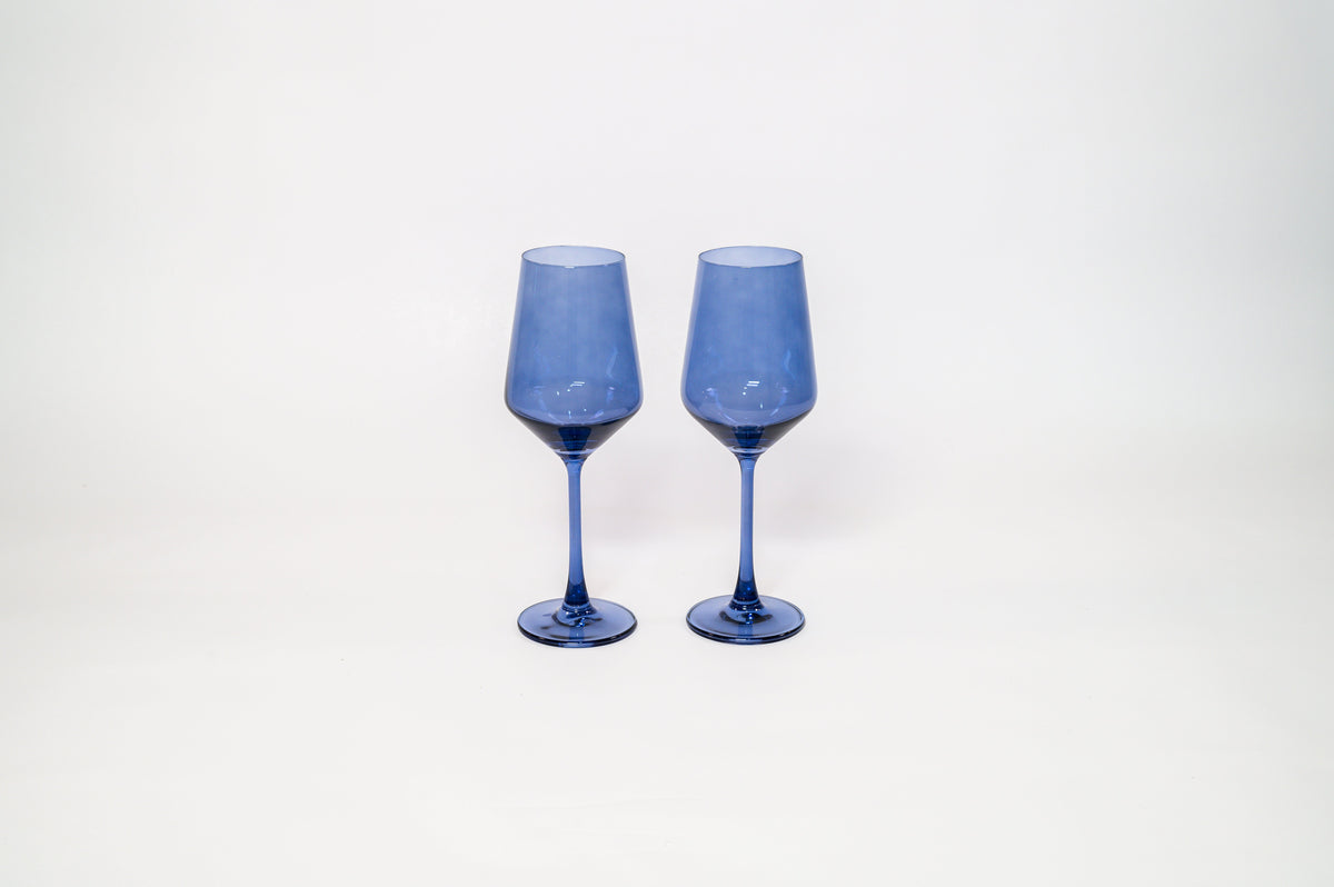 Pair of translucent blue-tinted wine glasses with long stems, set side by side against a plain white background.