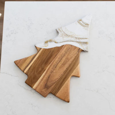 Christmas Tree shaped serving board made of acacia wood with green resin accent, styled with holiday snacks.