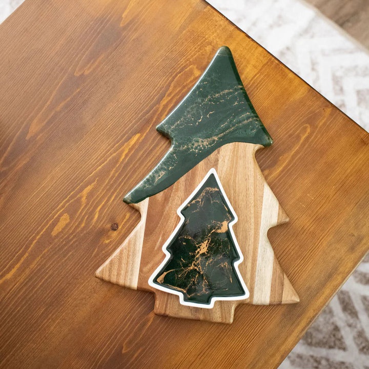 Christmas Tree shaped serving board made of acacia wood with green resin accent, styled with holiday snacks.