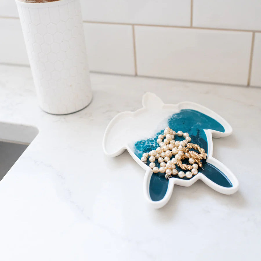 Decorative resin turtle plate with beads on a kitchen counter