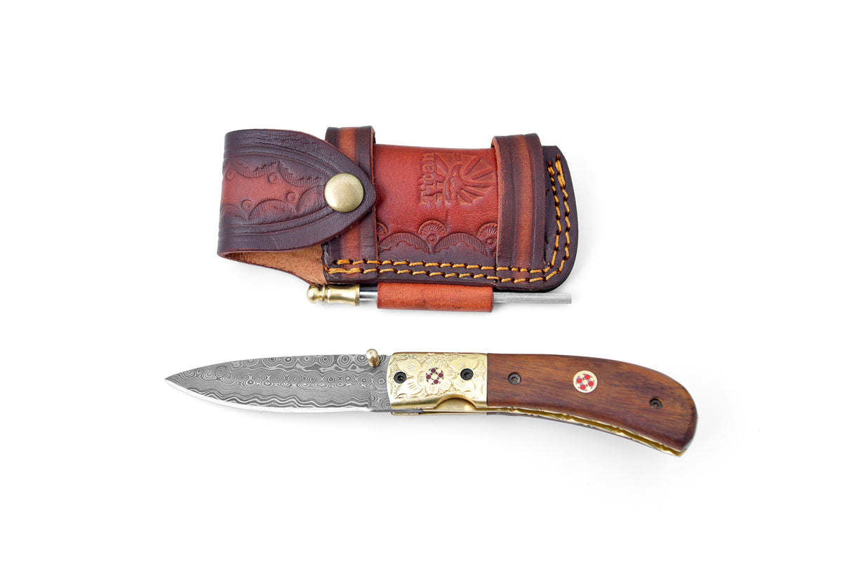 Nebula Cascade Folding Knife TF-053 with raindrop pattern blade and walnut wood handle next to leather sheath