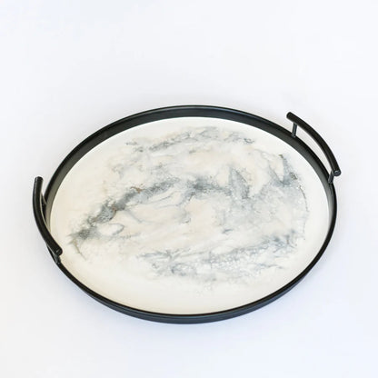 Marble-patterned stone on a black metal resin tray with handles against a white background