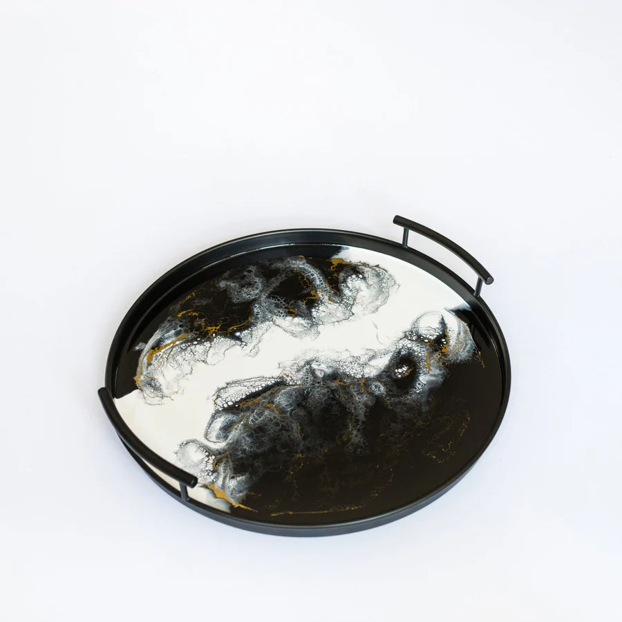 Decorative round resin tray with black frame on a white background