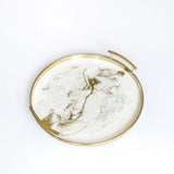 Round resin tray with gold rim and glossy resin accent on a white background