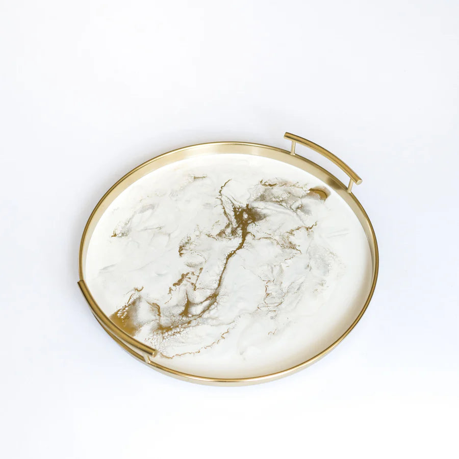 Round marble resin tray with gold rim and handles on a white background