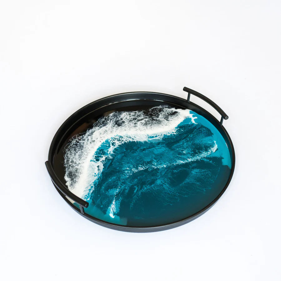 Decorative resin tray with ocean wave design on a white background