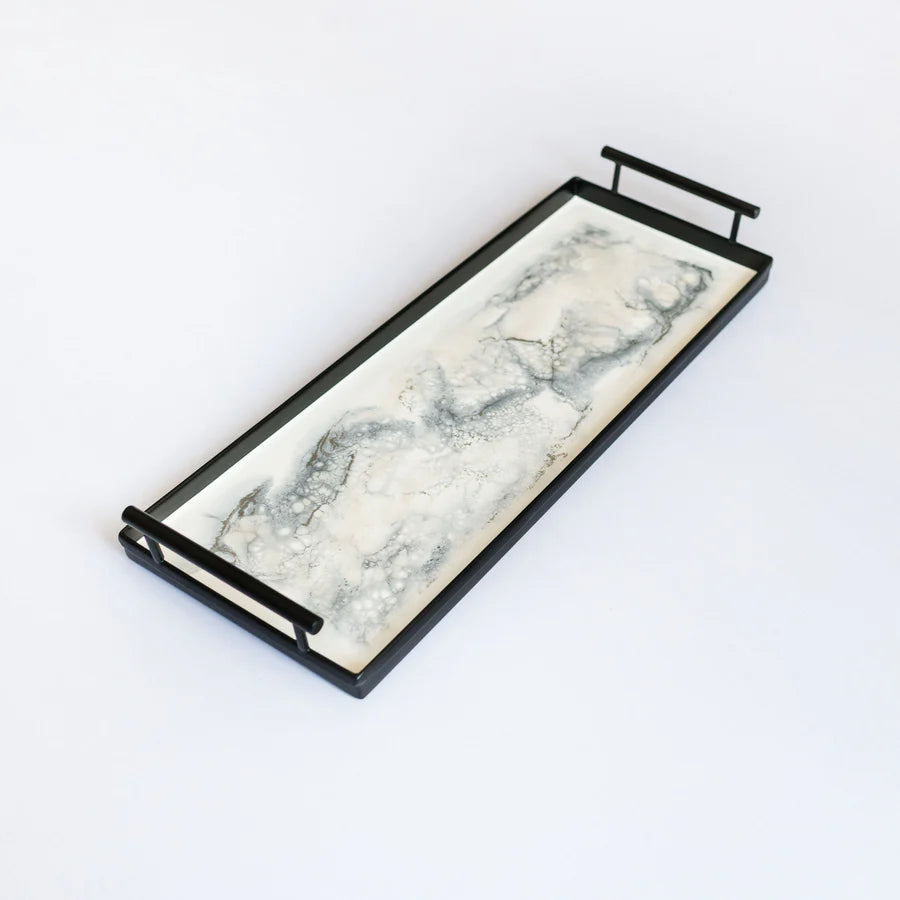 Marble-patterned resin tray with black metal handles on a white background