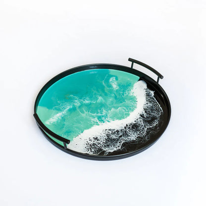 Round resin tray with ocean wave design on a white background