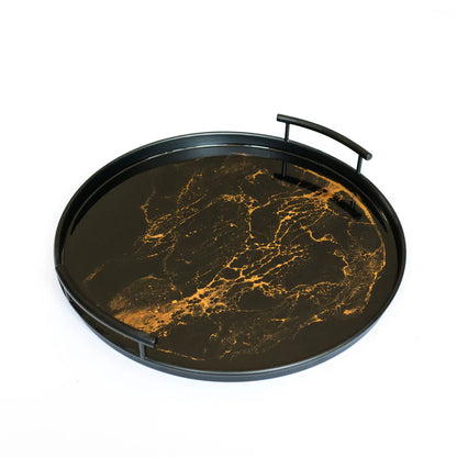 Round resin tray with black and gold marble pattern on a white background
