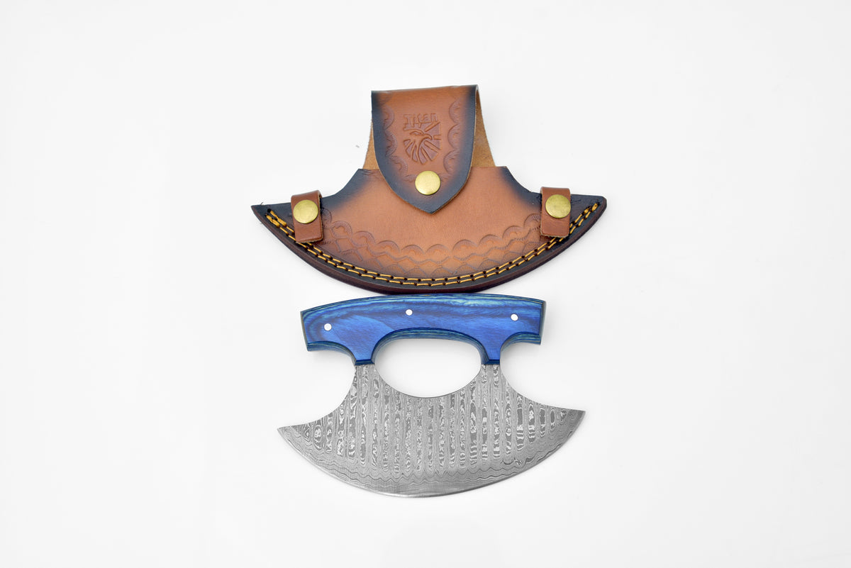 Damascus Steel Alaskan Ulu knife with Diamond Wood handle lying on a wooden surface
