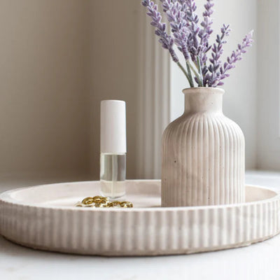 Fluted round resin stoneware tray in Limestone and Mocha Stone colors