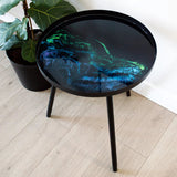 Resin Art Side Table with black metal frame and glossy resin-coated acacia wood tabletop in Northern Lights color