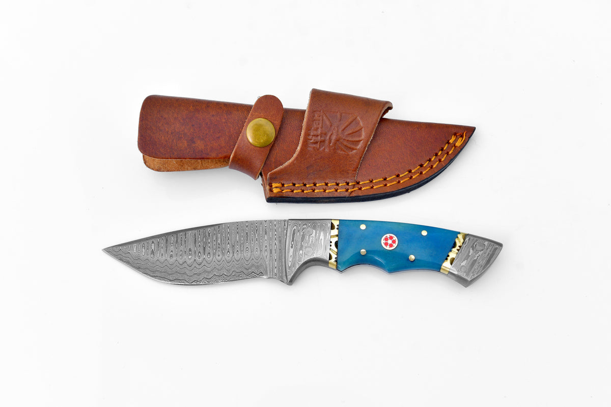 The Dyed Blue Bone Damascus Steel Utility Knife TK-001 with turquoise resin grip and patterned Damascus steel blade