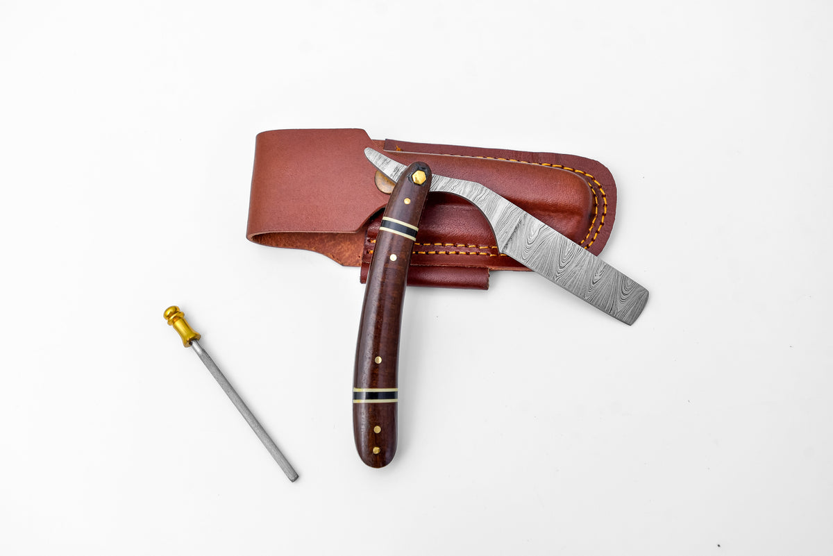 TD-042 fixed blade knife with Damascus steel blade and micarta handle resting on wooden surface