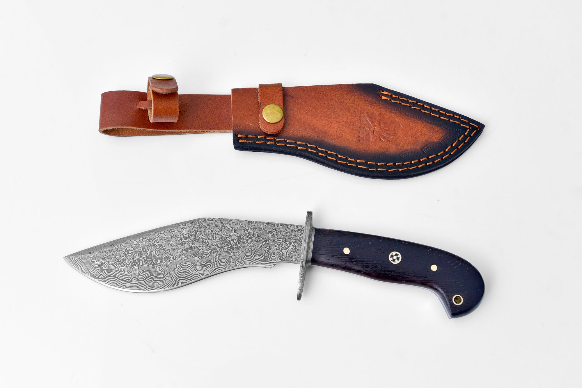 Damascus Steel Outdoor Chopping Tool with "Obsidian" dark Wenga wood handle laid on a textured surface