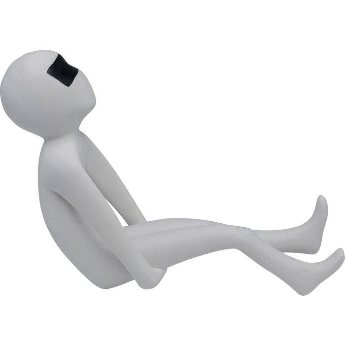 Minimalist white figurine with elongated limbs reclining and wearing black rectangular glasses, shown in profile on white background.