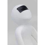 Smooth white resin figurine with an abstract human shape wearing a matte black rectangular visor across the eyes, shown in a close-up side view.
